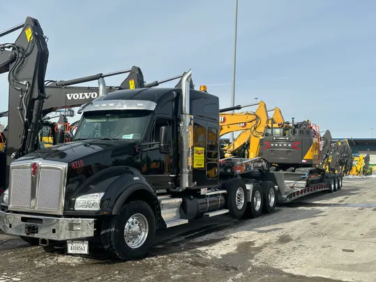 A truck with a heavy machinary on it